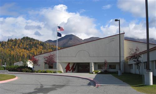 front of school with flags flying 